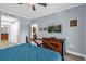 Main bedroom with large TV, dresser and access to bathroom at 1358 Centre Court Ridge Dr # 202, Reunion, FL 34747
