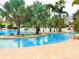Tropical pool with palm trees and lounge chairs at 1358 Centre Court Ridge Dr # 202, Reunion, FL 34747
