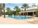 Resort-style pool with lounge chairs and palm trees at 1358 Centre Court Ridge Dr # 202, Reunion, FL 34747