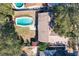 An aerial view of a backyard featuring a turquoise pool, patio, shed, and green space at 164 Morning Glory Dr, Lake Mary, FL 32746