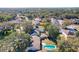 An aerial view of a neighborhood featuring mature trees, well-kept lawns, and in-ground pools at 164 Morning Glory Dr, Lake Mary, FL 32746