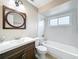 A modern bathroom featuring a vanity with storage, a round mirror, and a tub with a showerhead at 164 Morning Glory Dr, Lake Mary, FL 32746