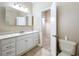 The bathroom features a single vanity with white cabinets and marble countertops and a tiled floor at 164 Morning Glory Dr, Lake Mary, FL 32746