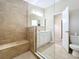 Beautiful bathroom featuring a shower with light tile and a single vanity with marble countertop at 164 Morning Glory Dr, Lake Mary, FL 32746