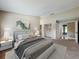Well-lit main bedroom boasts an ensuite bathroom and a spacious closet for ample storage at 164 Morning Glory Dr, Lake Mary, FL 32746