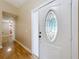 Inviting foyer with wood-look flooring and decorative glass front door providing an immediate sense of home at 164 Morning Glory Dr, Lake Mary, FL 32746