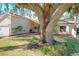 House exterior showcasing a large oak tree and well-maintained landscaping at 164 Morning Glory Dr, Lake Mary, FL 32746