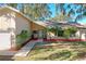 Inviting front of home featuring tidy landscaping, pops of color, and mature trees, making it feel like home at 164 Morning Glory Dr, Lake Mary, FL 32746