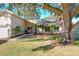 Beautifully landscaped front yard with mature trees offering ample shade and curb appeal to the charming home at 164 Morning Glory Dr, Lake Mary, FL 32746