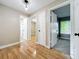 A light-filled hallway with wood floors leads to multiple rooms including a bathroom and bedroom at 164 Morning Glory Dr, Lake Mary, FL 32746