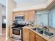 Galley kitchen featuring stainless steel appliances and granite countertops at 164 Morning Glory Dr, Lake Mary, FL 32746