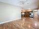 Living room with kitchen view, hardwood floors, and ceiling fan at 164 Morning Glory Dr, Lake Mary, FL 32746