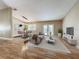 Bright living and dining area with wood floors, neutral paint, and modern lighting creating a comfortable living space at 164 Morning Glory Dr, Lake Mary, FL 32746