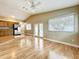 Living room with kitchen view, vaulted ceiling, hardwood floors, and natural light at 164 Morning Glory Dr, Lake Mary, FL 32746