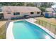 Relaxing kidney-shaped pool with safety fence and hot tub at 164 Morning Glory Dr, Lake Mary, FL 32746