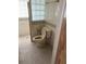 Clean bathroom with toilet and shower. Features a tiled floor and glass block window at 167 Benjamin Dr, Ormond Beach, FL 32176
