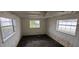 Small bedroom with wood paneling and worn floors at 167 Benjamin Dr, Ormond Beach, FL 32176