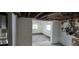 Dining room with worn floors and exposed ceiling beams at 167 Benjamin Dr, Ormond Beach, FL 32176