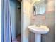 Clean bathroom with pedestal sink, shower, and gray tile at 1930 Albert Lee Pkwy, Winter Park, FL 32789