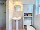 Clean bathroom with pedestal sink, shower, and gray tile at 1930 Albert Lee Pkwy, Winter Park, FL 32789