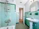 Updated bathroom with green tile and walk-in shower at 1930 Albert Lee Pkwy, Winter Park, FL 32789
