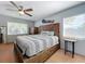 Spacious bedroom with wood flooring, large bed, and ceiling fan at 1930 Albert Lee Pkwy, Winter Park, FL 32789