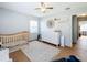 bedroom with crib, dresser, and ceiling fan at 1930 Albert Lee Pkwy, Winter Park, FL 32789