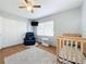 bedroom with crib, recliner, and ceiling fan at 1930 Albert Lee Pkwy, Winter Park, FL 32789