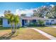Light blue house with a walkway, driveway, and palm trees at 1930 Albert Lee Pkwy, Winter Park, FL 32789
