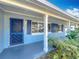 House exterior showcasing a covered porch with white columns and blue accents at 1930 Albert Lee Pkwy, Winter Park, FL 32789