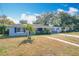 Light blue house with palm trees, walkway, and driveway at 1930 Albert Lee Pkwy, Winter Park, FL 32789