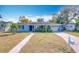 Newly painted light blue house with walkway and driveway at 1930 Albert Lee Pkwy, Winter Park, FL 32789