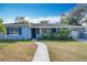 Ranch style home with light blue exterior and landscaped yard at 1930 Albert Lee Pkwy, Winter Park, FL 32789