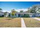 Charming light blue house with palm trees and a landscaped yard at 1930 Albert Lee Pkwy, Winter Park, FL 32789