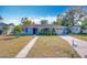 Ranch style home with a light blue exterior and landscaped yard at 1930 Albert Lee Pkwy, Winter Park, FL 32789