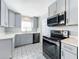 Updated kitchen featuring gray cabinets and stainless steel appliances at 1930 Albert Lee Pkwy, Winter Park, FL 32789
