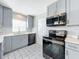 Modern kitchen with gray cabinets and patterned tile floor at 1930 Albert Lee Pkwy, Winter Park, FL 32789