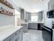 Modern kitchen with gray cabinets, quartz counters, and patterned floor at 1930 Albert Lee Pkwy, Winter Park, FL 32789