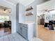 Gray cabinets, quartz countertops, and patterned tile flooring highlight this kitchen at 1930 Albert Lee Pkwy, Winter Park, FL 32789