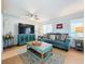 Bright living room with comfy couches, wood floors, and large TV at 1930 Albert Lee Pkwy, Winter Park, FL 32789