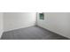 Bedroom with grey carpet and window overlooking street at 2623 Sage Valley Way, Winter Haven, FL 33884