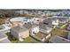 Aerial view of houses with fenced backyards and solar panels at 2630 Angel Falls Dr, Davenport, FL 33837