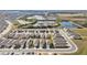 Aerial view of houses, a pond, and a large undeveloped area at 2630 Angel Falls Dr, Davenport, FL 33837