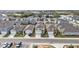 Aerial view of a neighborhood with houses near a lake at 2630 Angel Falls Dr, Davenport, FL 33837