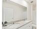 Bathroom with dual sinks, granite countertop, and white cabinets at 2630 Angel Falls Dr, Davenport, FL 33837