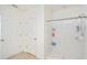 Bright bathroom featuring a shower, white fixtures, and neutral tile flooring at 2630 Angel Falls Dr, Davenport, FL 33837