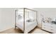 Bedroom with gold canopy bed, light wood floors, and modern decor at 2630 Angel Falls Dr, Davenport, FL 33837