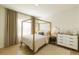 Bright bedroom with canopy bed, light-colored drapes, and plush rug at 2630 Angel Falls Dr, Davenport, FL 33837