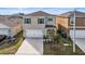 Two-story house with a white garage door and green shutters at 2630 Angel Falls Dr, Davenport, FL 33837