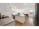 Open kitchen overlooking the dining and living area with stainless steel appliances and granite countertops at 2630 Angel Falls Dr, Davenport, FL 33837